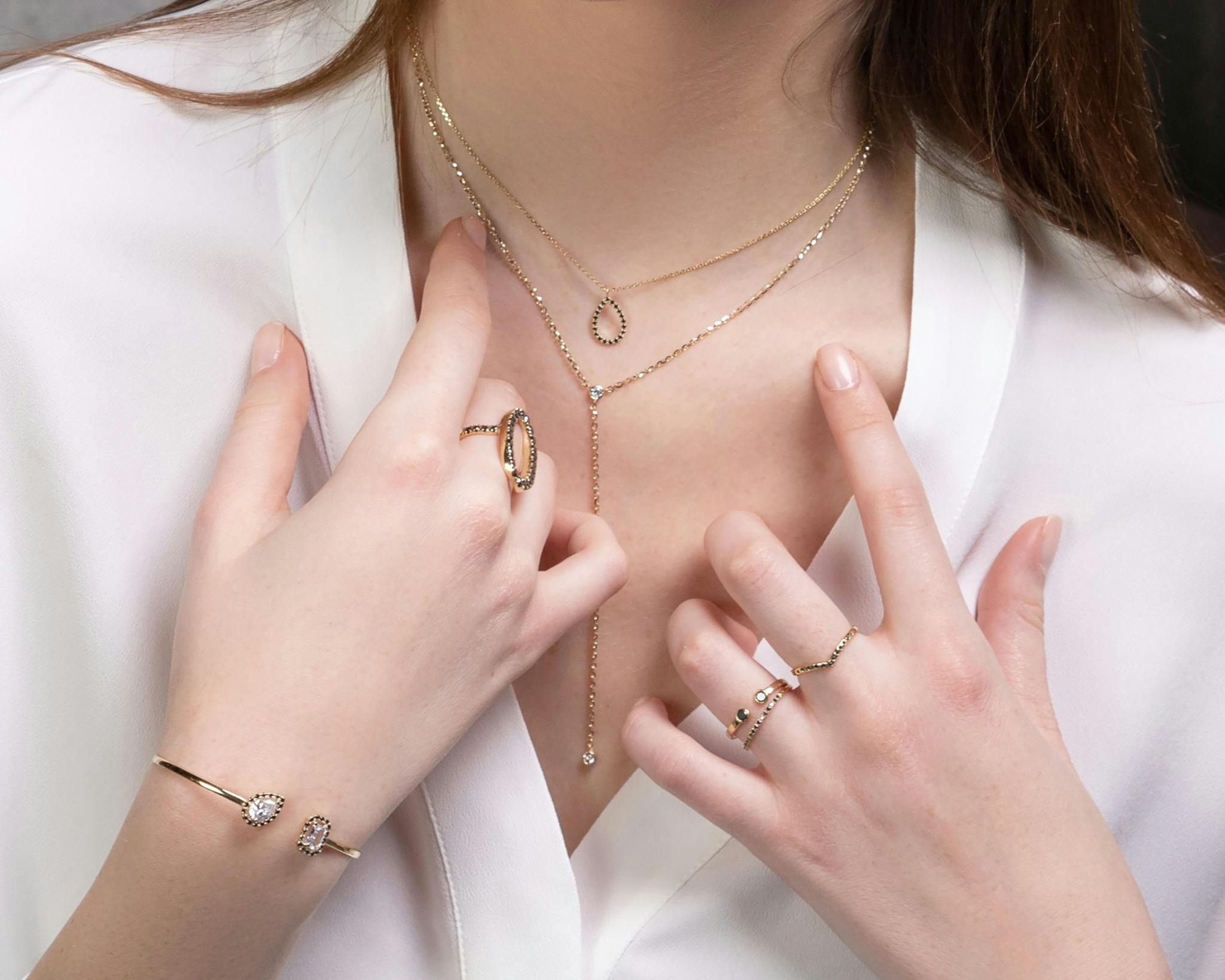 Layered gold necklaces and rings styled for everyday jewellery inspiration